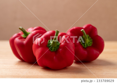 Fresh red bell pepper or sweet pepper on wooden background Fresh red bell pepper or sweet pepper on wooden background 133789029