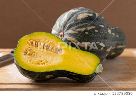 Half green butternut squash pumpkin on cutting wooden board 133789050