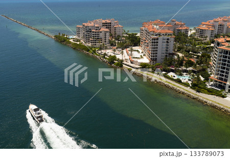 Yacht cruising near Miami Beach. Aerial view of boats on turquoise waters in Miami. Yacht retreat in South Florida Miami. 133789073