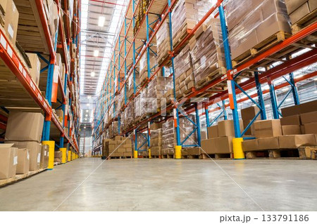 Low angle view cardboard boxes on rack in illuminated warehouse Low angle view cardboard boxes on rack in illuminated warehouse 133791186