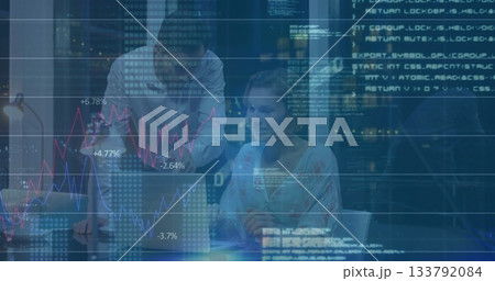 Collaborating colleagues reviewing code around laptop in night office, with desk lamp mug papers 133792084