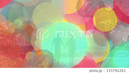 Walking senior couple holding hands on shallow sandy shore, with translucent circles over sea waves Walking senior couple holding hands on shallow sandy shore, with translucent circles over sea waves 133792261