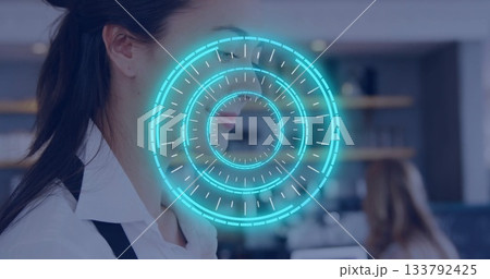 Standing barista wearing black apron with blue holographic interface in café, copy space 133792425