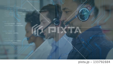Call center agent in patterned shirt handling calls in office, headsets and monitors, copy space 133792884