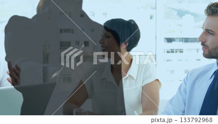 Discussing strategy three business professionals meeting at conference room glass table reflections Discussing strategy three business professionals meeting at conference room glass table reflections 133792968