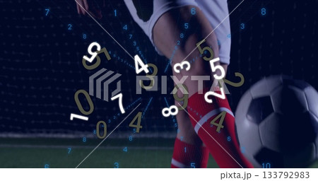 Preparing player's legs in red socks driving soccer ball on stadium turf, with analytics overlay 133792983