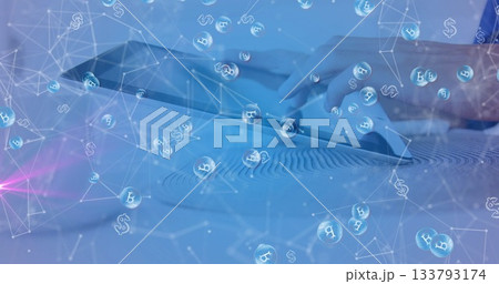 Touching tablet screen while viewing floating Bitcoin and dollar symbols on Zen garden tabletop 133793174