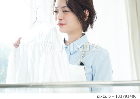 洗濯物を干す若い女性 133793486