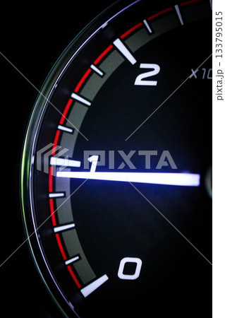 Close-up of a diesel truck's dashboard and tachometer. It represents the power and durability of a work vehicle, with a clear focus on the round engine meters. Close-up of a diesel truck's dashboard and tachometer. It represents the power and durability of a work vehicle, with a clear focus on the round engine meters. 133795015