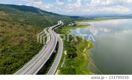 Drone shot The M6 motorway Nakhon Ratchasima Province - Bang Pa-in Lam Ta Khong River and Mountain. Motorway Korat Thailand Drone shot The M6 motorway Nakhon Ratchasima Province - Bang Pa-in Lam Ta Khong River and Mountain. Motorway Korat Thailand 133795030