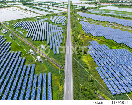 Aerial view drone shot scenic landscape of a road passing through a solar farm in Thailand 133795036