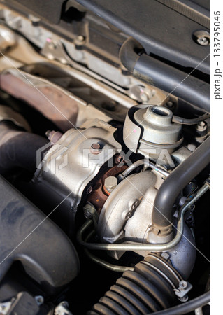 Close-up of car turbocharger system showing engine detail, metal texture, and automotive technology concept Close-up of car turbocharger system showing engine detail, metal texture, and automotive technology concept 133795046