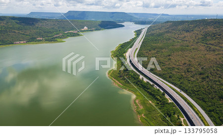 Drone shot The M6 motorway Nakhon Ratchasima Province - Bang Pa-in Lam Ta Khong River and Mountain. Motorway Korat Thailand Drone shot The M6 motorway Nakhon Ratchasima Province - Bang Pa-in Lam Ta Khong River and Mountain. Motorway Korat Thailand 133795058