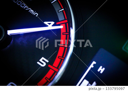 Close-up of a diesel truck's dashboard and tachometer. It represents the power and durability of a work vehicle, with a clear focus on the round engine meters. Close-up of a diesel truck's dashboard and tachometer. It represents the power and durability of a work vehicle, with a clear focus on the round engine meters. 133795097
