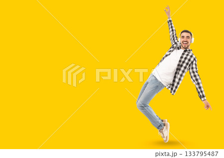 Dancer with headphones on a bright yellow background Dancer with headphones on a bright yellow background 133795487