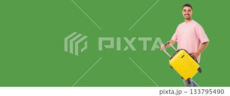 Person with yellow suitcase stands confidently outdoors 133795490