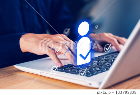 Business hand using laptop with digital user icons and check marks, representing online identity verification, HR selection, recruitment system, and secure user management for modern digital Business hand using laptop with digital user icons and check marks, representing online identity verification, HR selection, recruitment system, and secure user management for modern digital 133795839