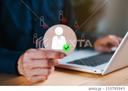 Hand selecting a candidate with green checkmark icon among rejected applicants, symbolizing recruitment, HR selection, or hiring decision in a business setting. Suitable for HR or job concept. 133795843