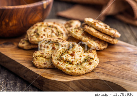 Crunchy salted crackers on wooden table. 133795930