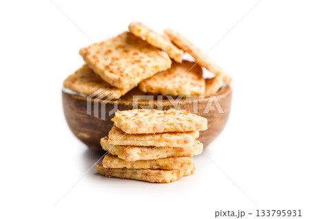 Crunchy salted crackers in bowl isolated on white background. Crunchy salted crackers in bowl isolated on white background. 133795931