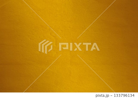 Textured yellow surface is filling entire frame, showcasing subtle creases in flat design 133796134