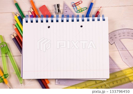 Flat design showing notebook on wooden desk surrounded by pencils, rulers, compass, copy space Flat design showing notebook on wooden desk surrounded by pencils, rulers, compass, copy space 133796450