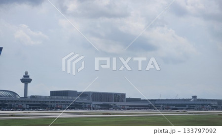 Changi Airport lush greenery spells its name beside a busy runway 133797092