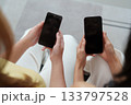 Social Media Connection. Two friends holding smartphones with blank screens. 133797528