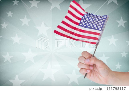 Cropped image of hand holding American flag 133798117
