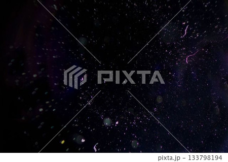 Luminescent specks and faint purple white streaks are drifting in dark void digital illustration Luminescent specks and faint purple white streaks are drifting in dark void digital illustration 133798194