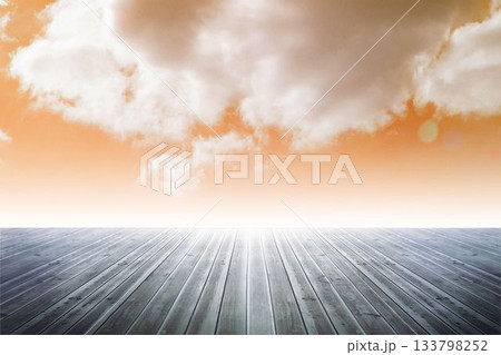 Flat design showing wooden deck extending toward horizon under orange sky with subtle lens flare Flat design showing wooden deck extending toward horizon under orange sky with subtle lens flare 133798252