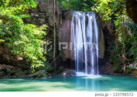 Beautiful Erawan waterfall in the dense tropical forest of Kanchanaburi Province, Thailand. Amazing waterfall with emerald lake in Erawan National Park in Kanchanaburi, Thailand. 133798572