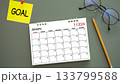calendar of New Year 2026, January with word GOAL on post-it paper pin on green background, pencil and eyeglasses beside. symbolize New Year targets, resolutions, strategy, progress, and fresh starts 133799588