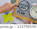 hand holding a magnifying glass points to the word Success 2026 on letter board with text plan, symbolizing fresh goals, motivation, and starts new year personal fresh planning. 133799590