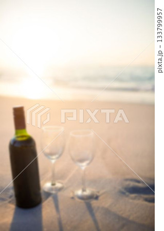 Wine bottle and wineglasses on sand Wine bottle and wineglasses on sand 133799957