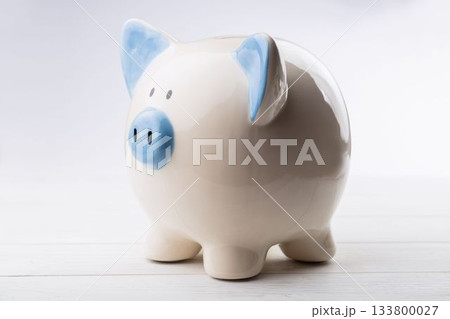 Close-up of piggy bank on wooden table 133800027