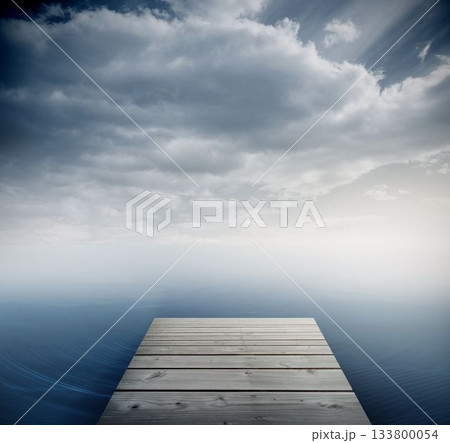 Wooden dock is extending into calm water, merging with misty horizon beneath clouds, flat design Wooden dock is extending into calm water, merging with misty horizon beneath clouds, flat design 133800054