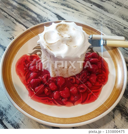 Meringue cake with raspberry sauce Meringue cake with raspberry sauce 133800475