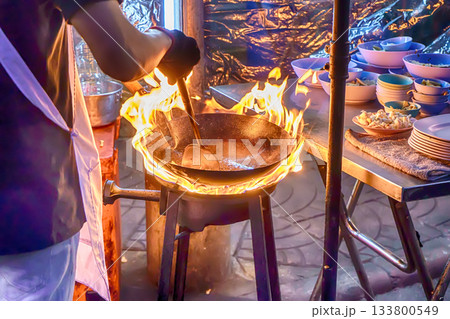 Stir frying with high flame Stir frying with high flame 133800549