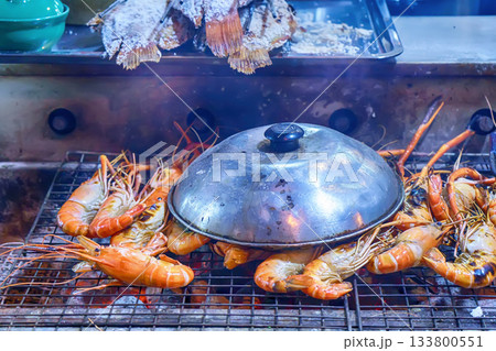 Grilling river prawns on stove 133800551