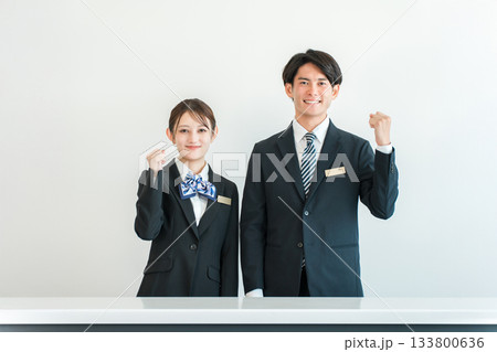 カウンター,フロントで働くコンシェルジュ,ホテリエ,フロントスタッフの男女(ガッツポーズ) カウンター,フロントで働くコンシェルジュ,ホテリエ,フロントスタッフの男女(ガッツポーズ) 133800636