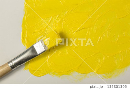Yellow paint with paintbrush 133801396