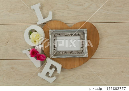 Photo frame with love alphabet on table Photo frame with love alphabet on table 133802777