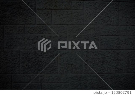 rough-textured dark gray stone brick wall is showcasing flat design with chiseled marks and shadows rough-textured dark gray stone brick wall is showcasing flat design with chiseled marks and shadows 133802791
