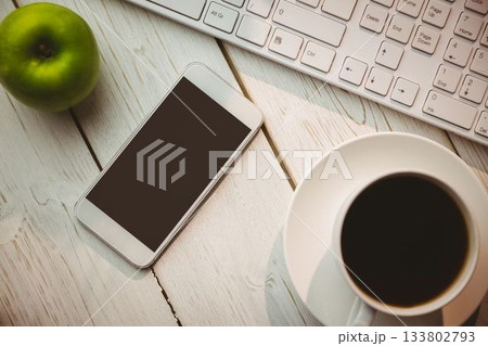 White smartphone is resting on wooden desk in flat design, with coffee cup and green apple White smartphone is resting on wooden desk in flat design, with coffee cup and green apple 133802793