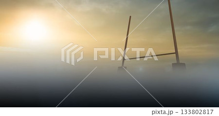 Rugby goal post is rising from misty ground fog under golden dawn sky in flat design 133802817