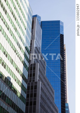 Three high-rise office towers are rising in flat design, showing concrete beams and glass panels Three high-rise office towers are rising in flat design, showing concrete beams and glass panels 133802947