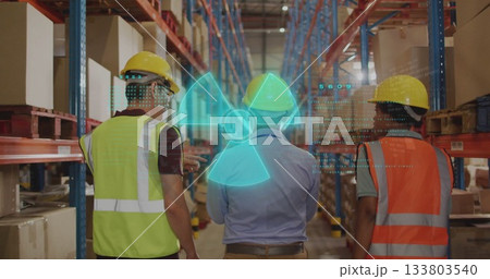 Staff scanning holographic radiation symbol in warehouse aisle, with metal racks and safety gear 133803540