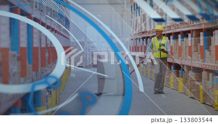 Pushing manual pallet jack male warehouse worker checking tablet in aisle, with boxes, copy space Pushing manual pallet jack male warehouse worker checking tablet in aisle, with boxes, copy space 133803544