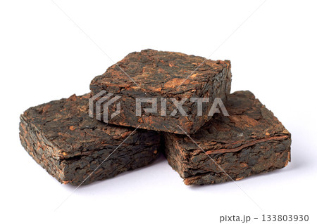 Black pu-erh Chinese tea. Pressed tiles of fermented black tea isolated on white background. 133803930